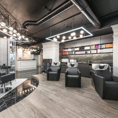 Contemporary hair salon interior showcasing modern decor and styling equipment.